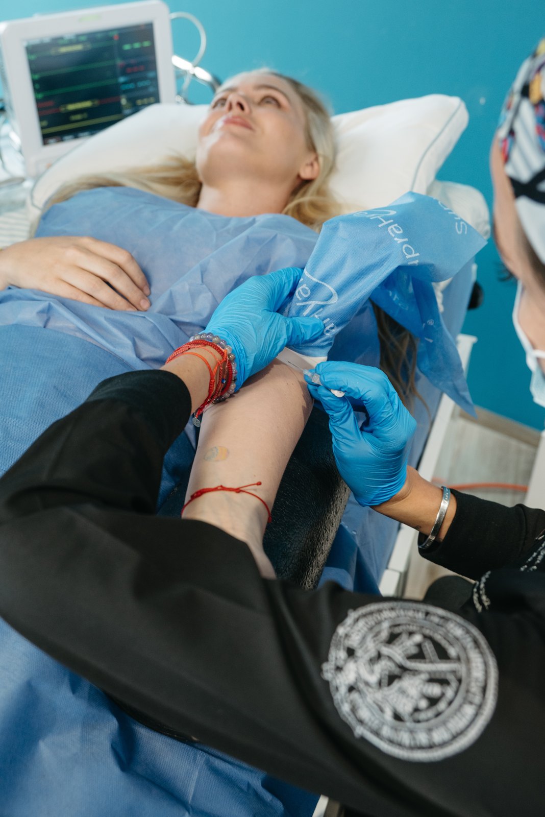 A patient receiving IV therapy under monitoring at Neorgana